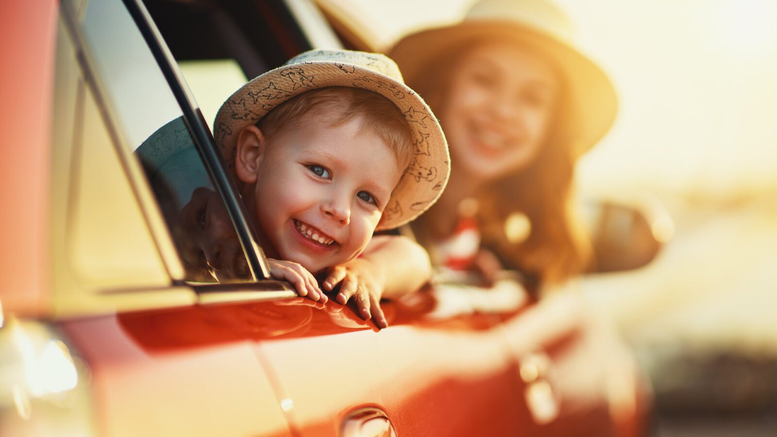 happy family mother and child boy goes to summer travel trip in car